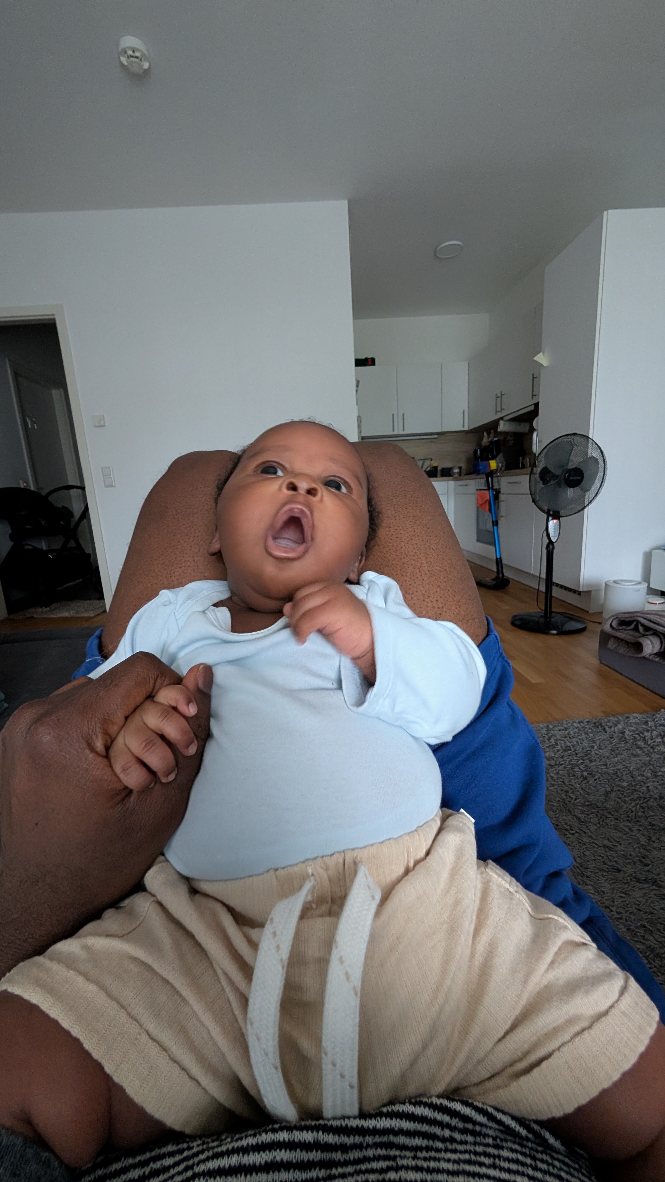 Baby sitting upright in a light blue outfit