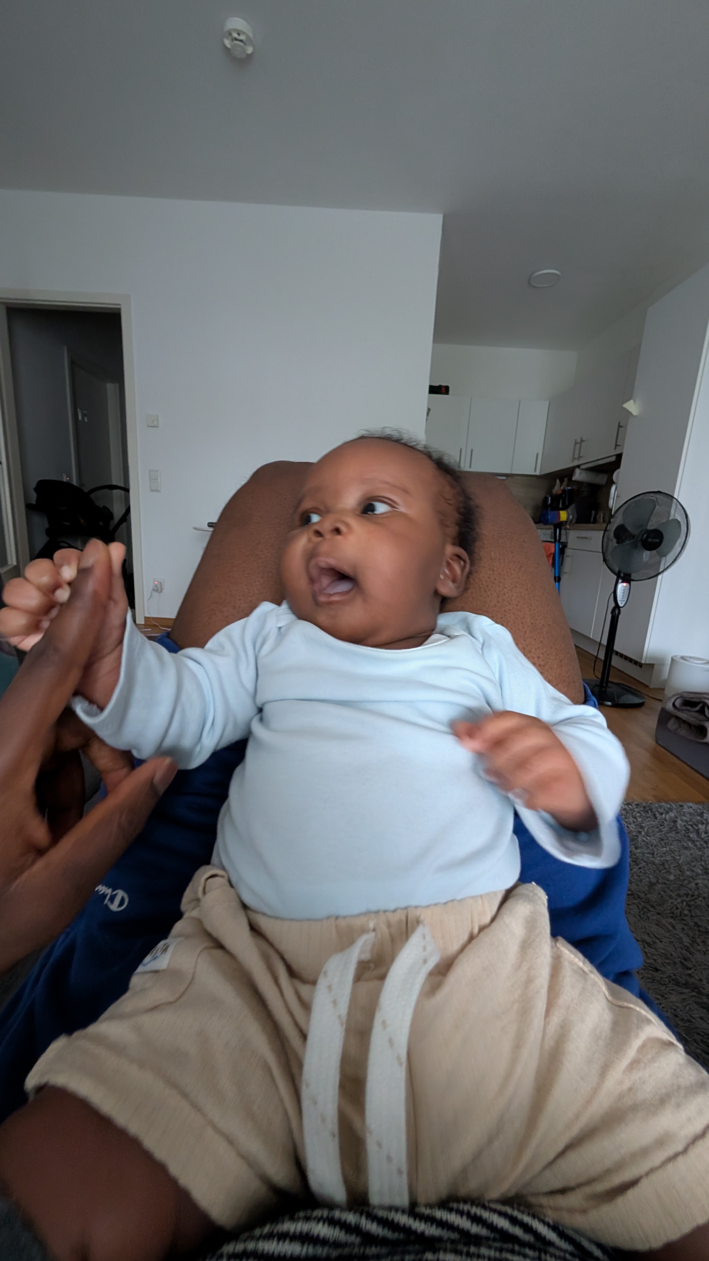 Baby sitting upright at home